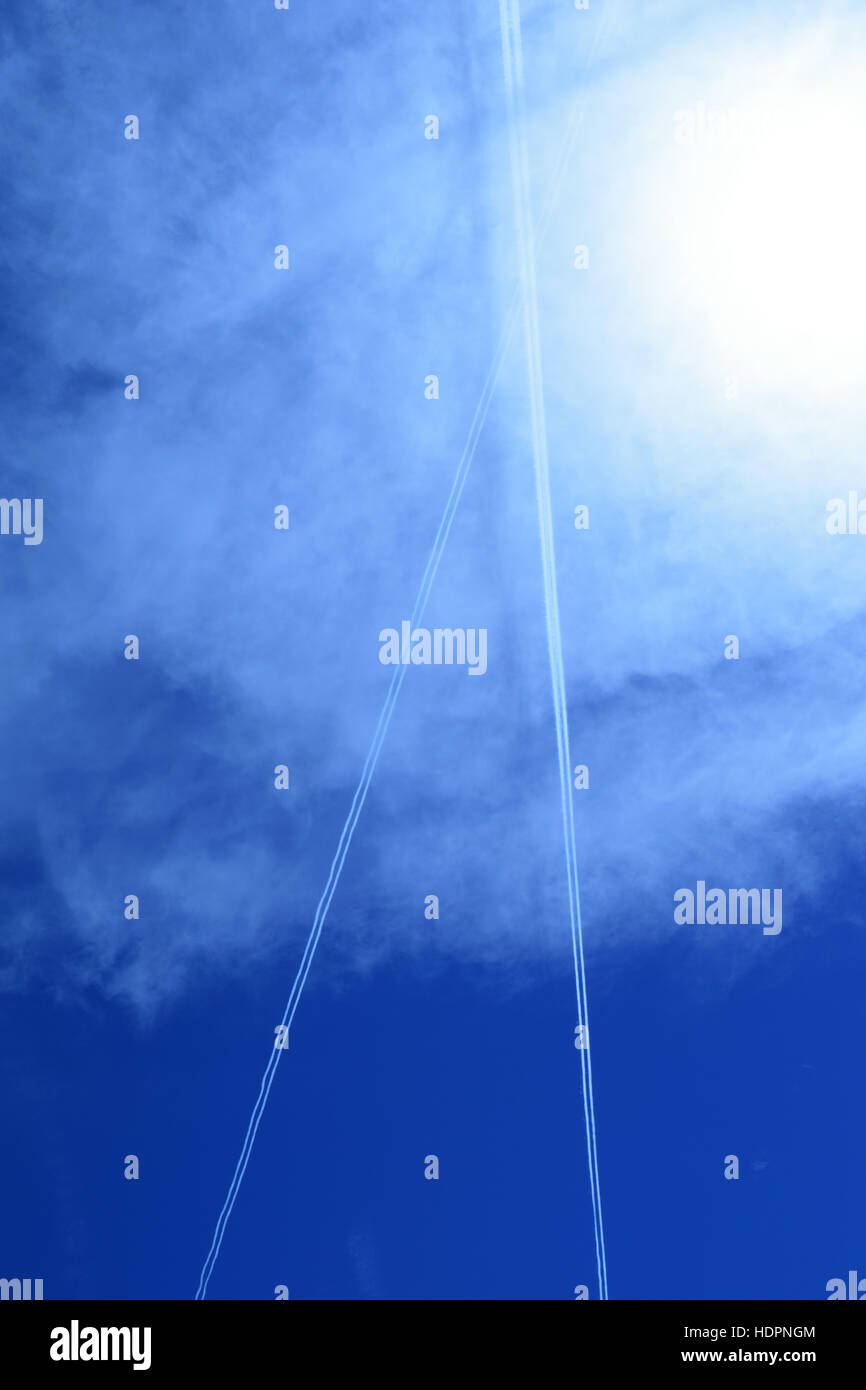 lines of jet streams on blue sky background - vertical - portrait Stock Photo