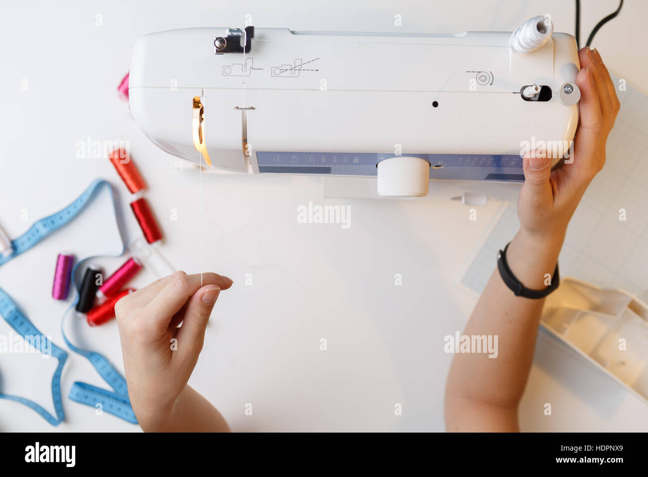 Girl preparing work on sewingmachine Stock Photo Alamy