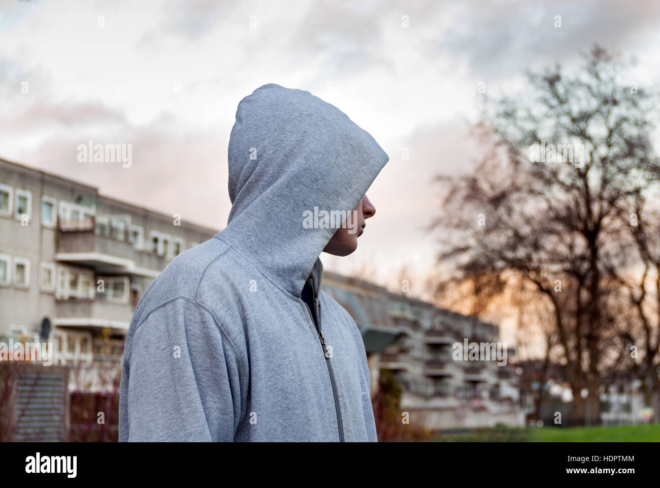 Teenager hanging around wearing hoodie top, London, UK Stock Photo
