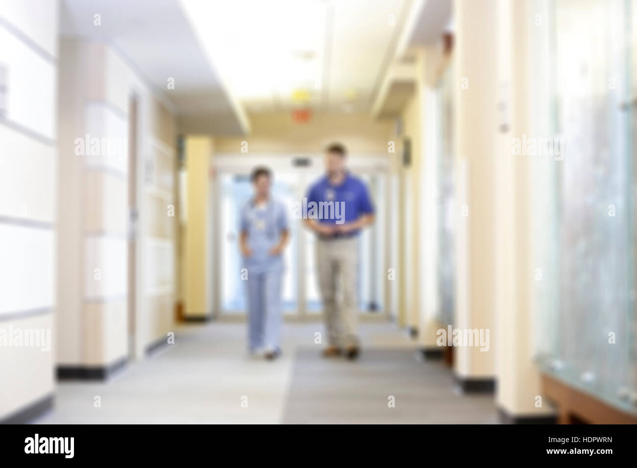 Blurred Hospital Hallway with Caregivers walking Stock Photo