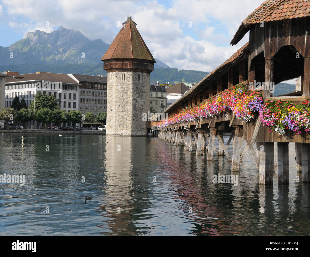 Famous Chapel Bridge and Mount Pilatus in Lucerne, Switzeland on a clear summer day. Stock Photo