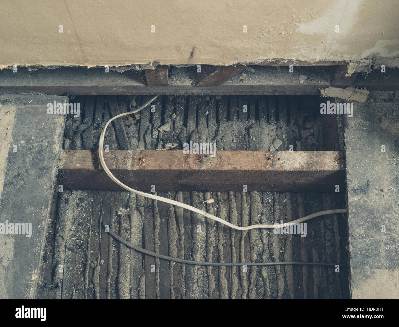 Cables running under the floor boards in a room that is being renovated Stock Photo Alamy