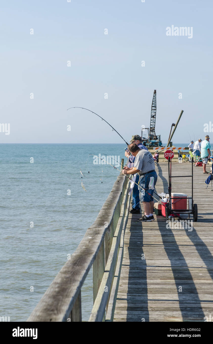 People fishing on Oceanana Fishing Pier,  Atlantic Beach, Outer Banks, North Carolina, USA. Stock Photo