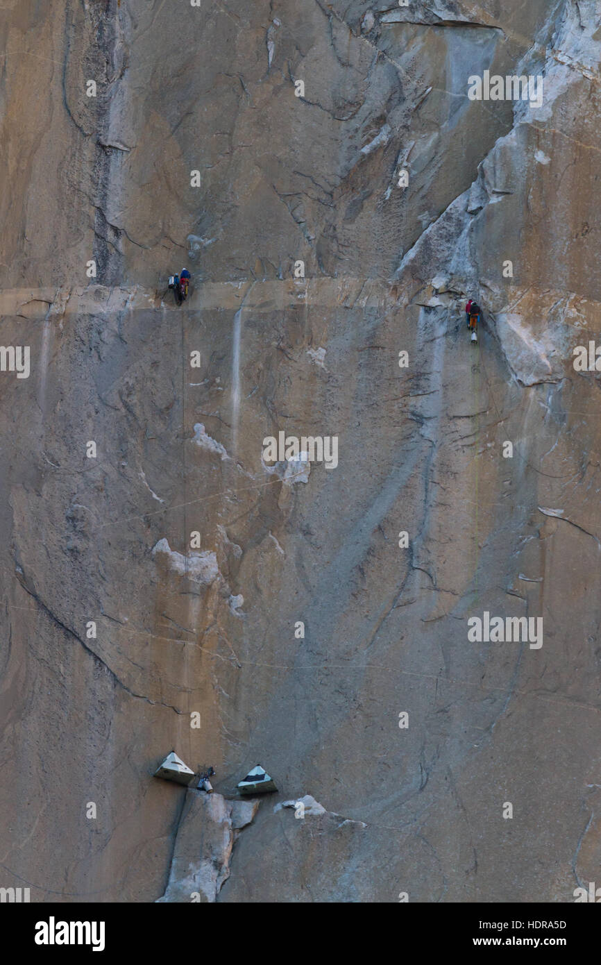 Camping tents suspended from the cliff and two sets of climbers on the