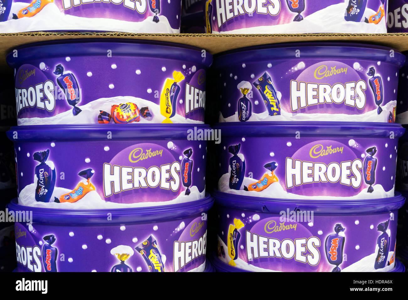 Stacked tins of Cadbury Heroes chocolates waiting to be sold for Christmas. Stock Photo