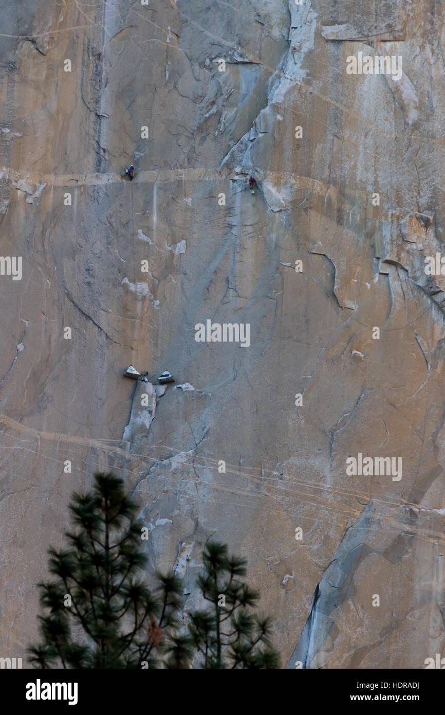 Camping tents suspended from the cliff and two sets of climbers on the