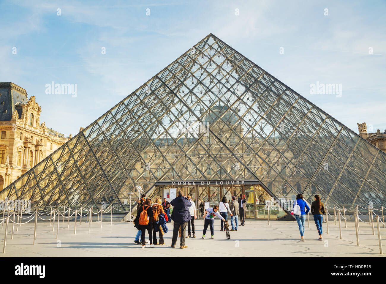 PARIS - NOVEMBER 1: The Louvre Pyramid on November 1, 2014 in Paris, France. It serves as the main entrance to the Louvre Museum. Completed in 1989 Stock Photo