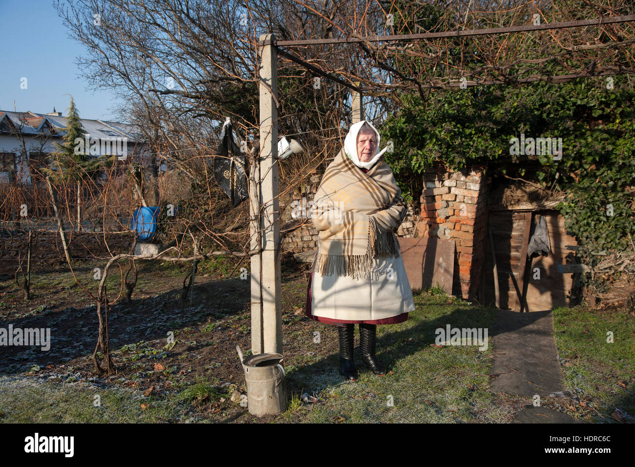 Woman stands in her back garden wearing the traditional costume of the southern region of Moravia Stock Photo