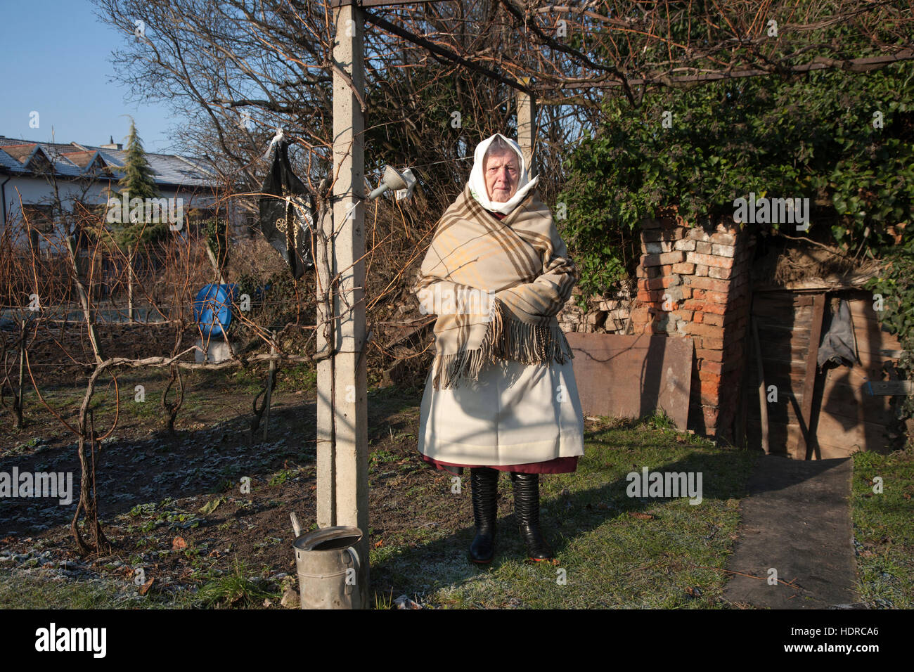 Woman stands in her back garden wearing the traditional costume of the southern region of Moravia Stock Photo