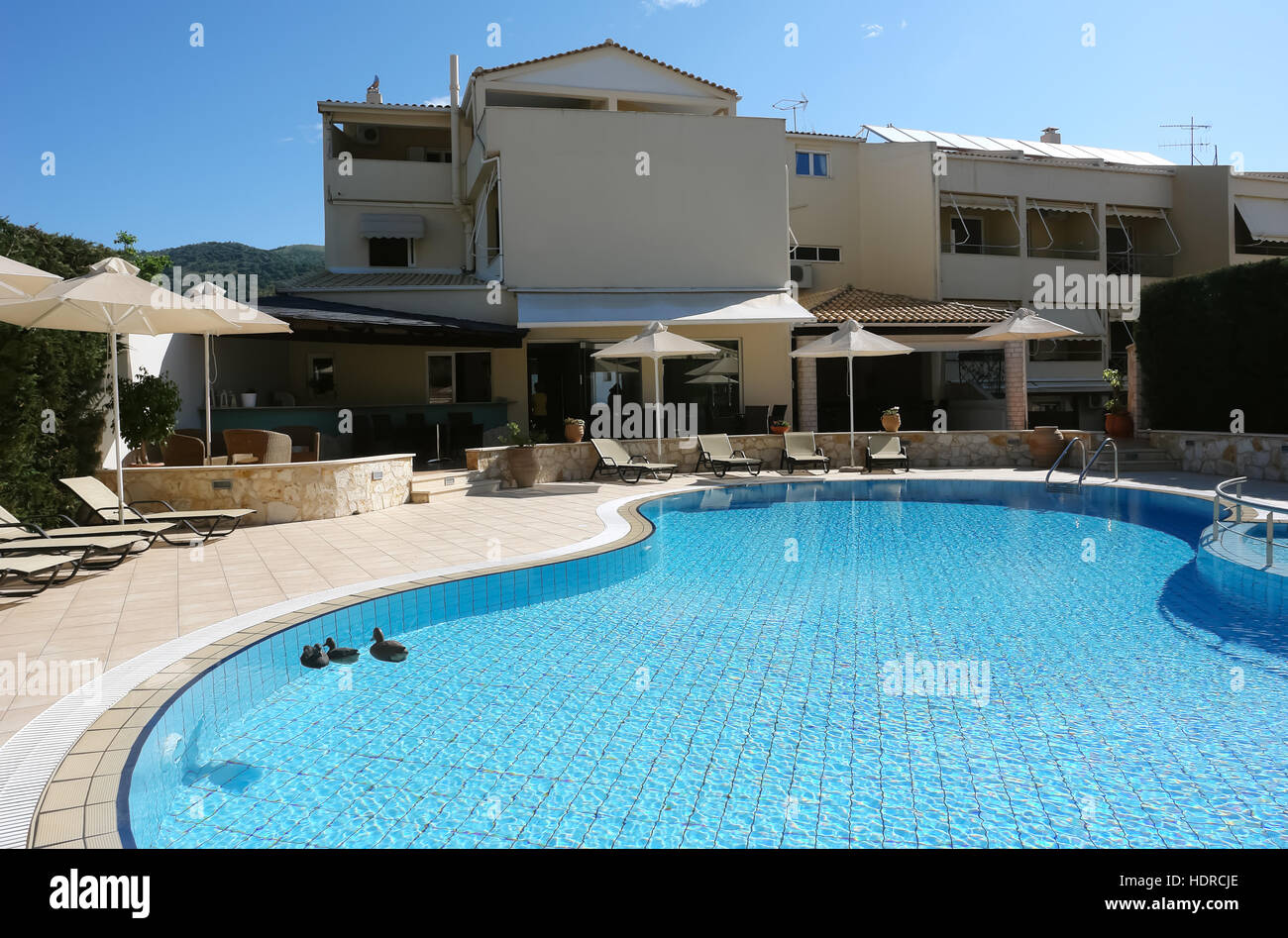Sivota Greece May 09 2013 View On Blue Swimming Pool And Umbrellas
