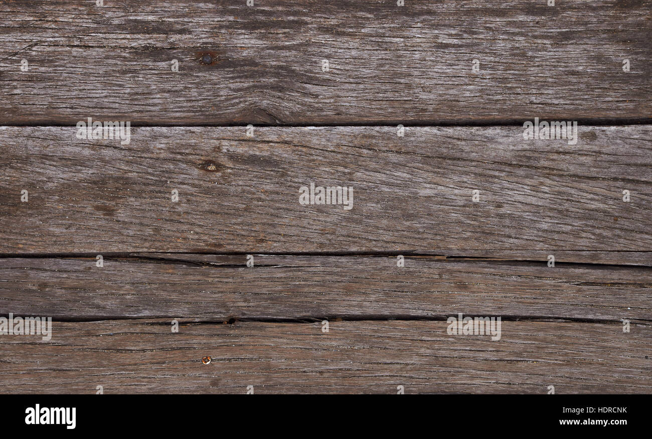 Old vintage aged grunge dark brown wooden horizontal floor planks texture background with stains and nails Stock Photo