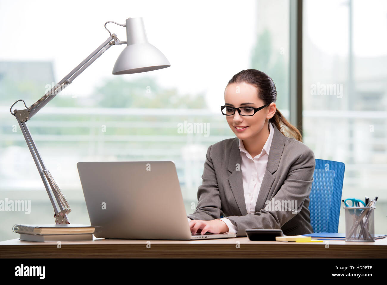 Businesswoman working at her desk Stock Photo - Alamy