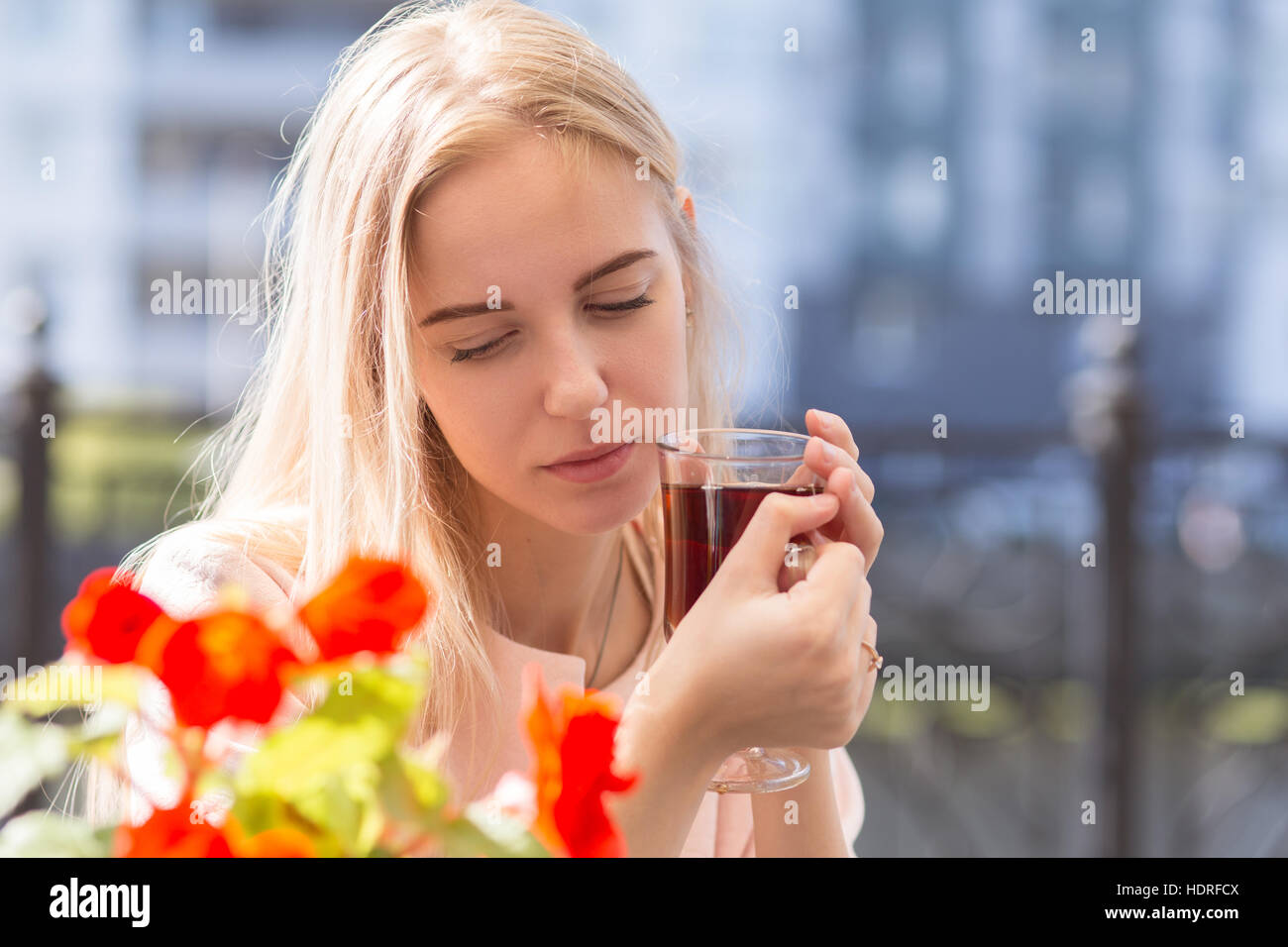 sad blond woman with cup of tea in street cafe Stock Photo - Alamy
