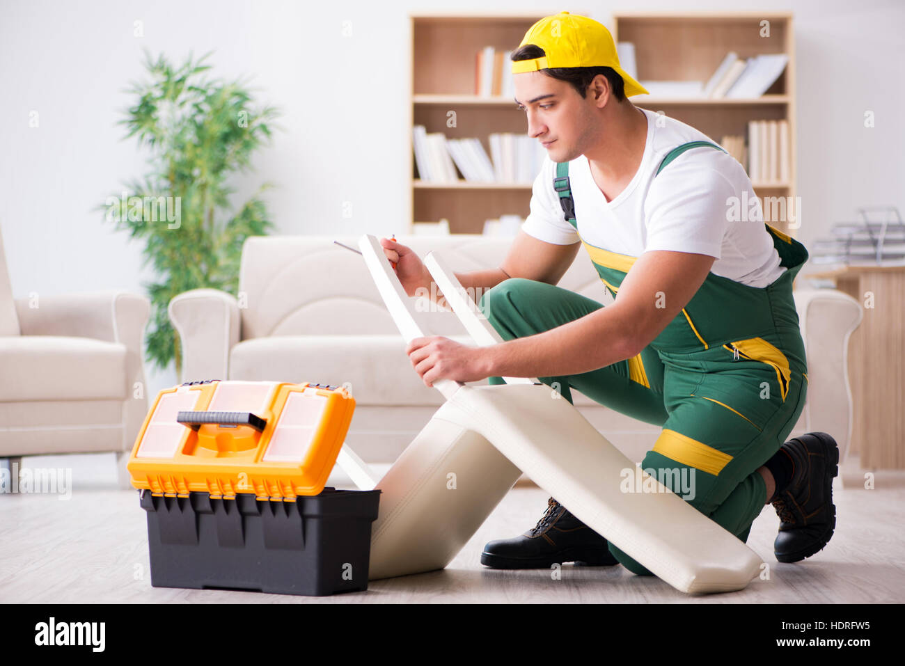 Furniture repairman repairing armchair at home Stock Photo Alamy
