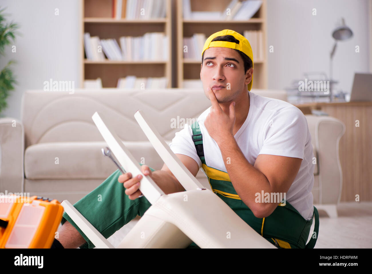 Furniture repairman repairing armchair at home Stock Photo Alamy