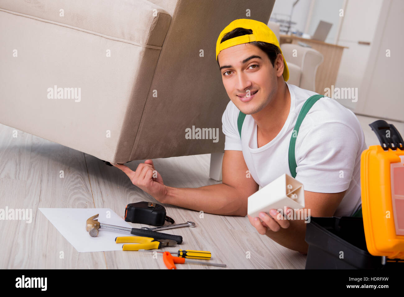 Furniture repairman repairing armchair at home Stock Photo Alamy