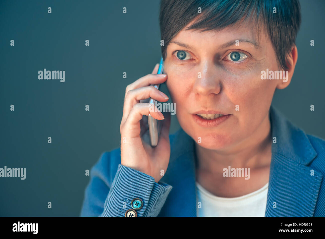 Business woman talking on mobile phone, close up headshot Stock Photo