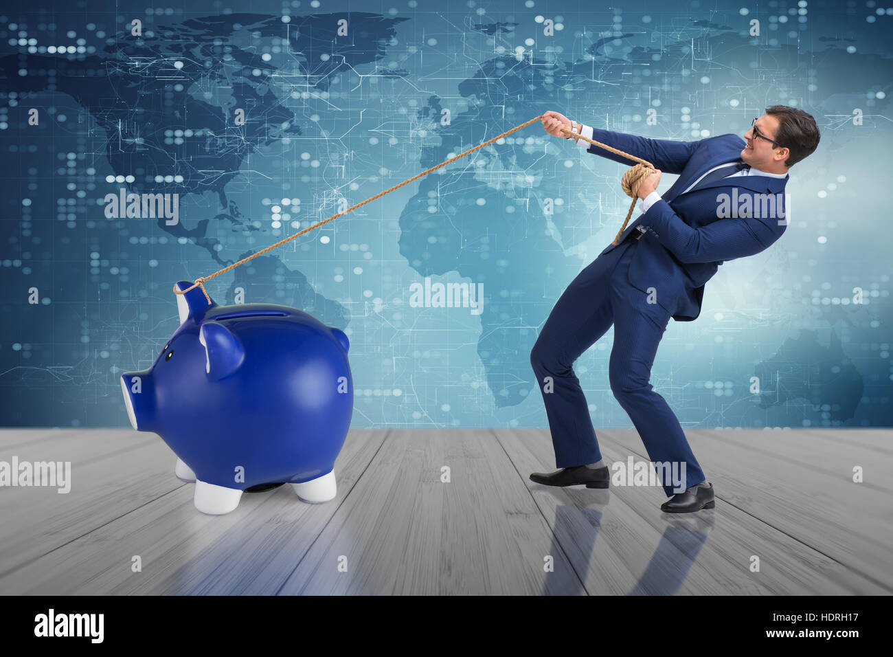 Businessman pulling piggybank with rope Stock Photo - Alamy