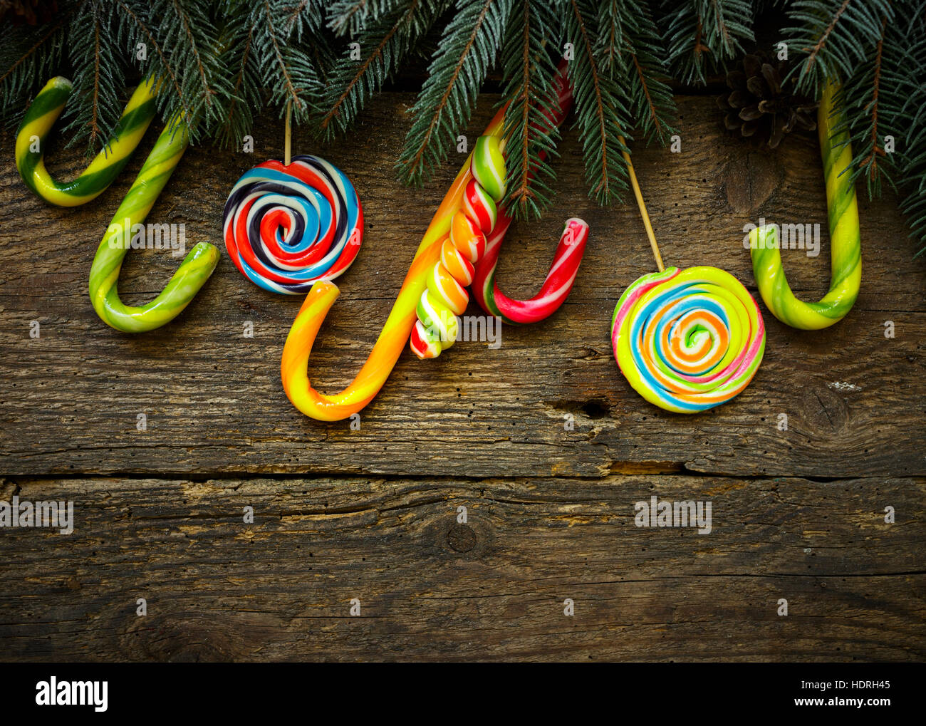 Christmas border with fir tree branches, pine cones and candy cane on ...