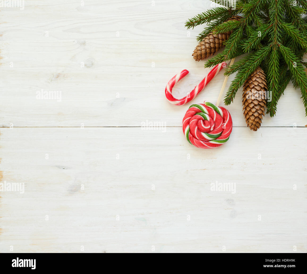 Christmas border with fir tree branches with cones and candy cane on ...