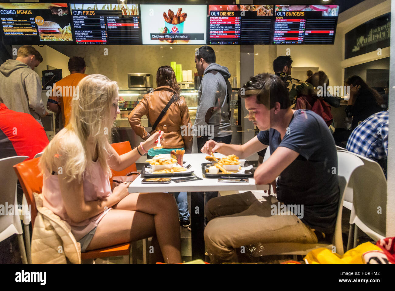 Young couple eating fast food in Bruge, Belgium Stock Photo