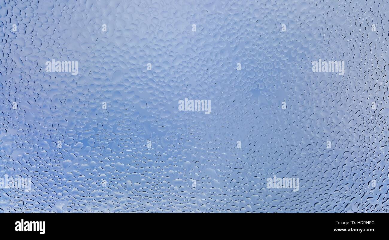 Water drops on glass with blurred blue sky background Stock Photo - Alamy