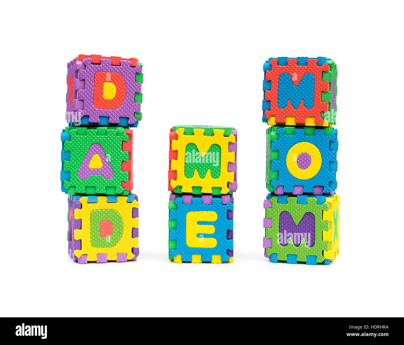 DAD ME MOM shaped by alphabet jigsaw puzzle on white as concept of family Stock Photo
