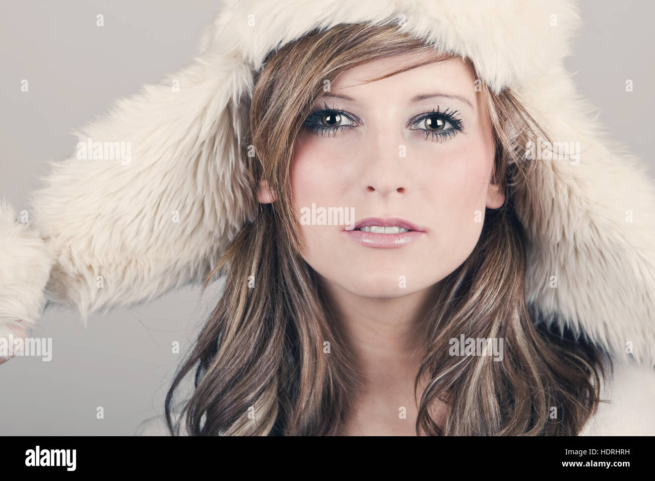 Beautiful Teenage Girl in Winter Hat against Grey Background Stock Photo