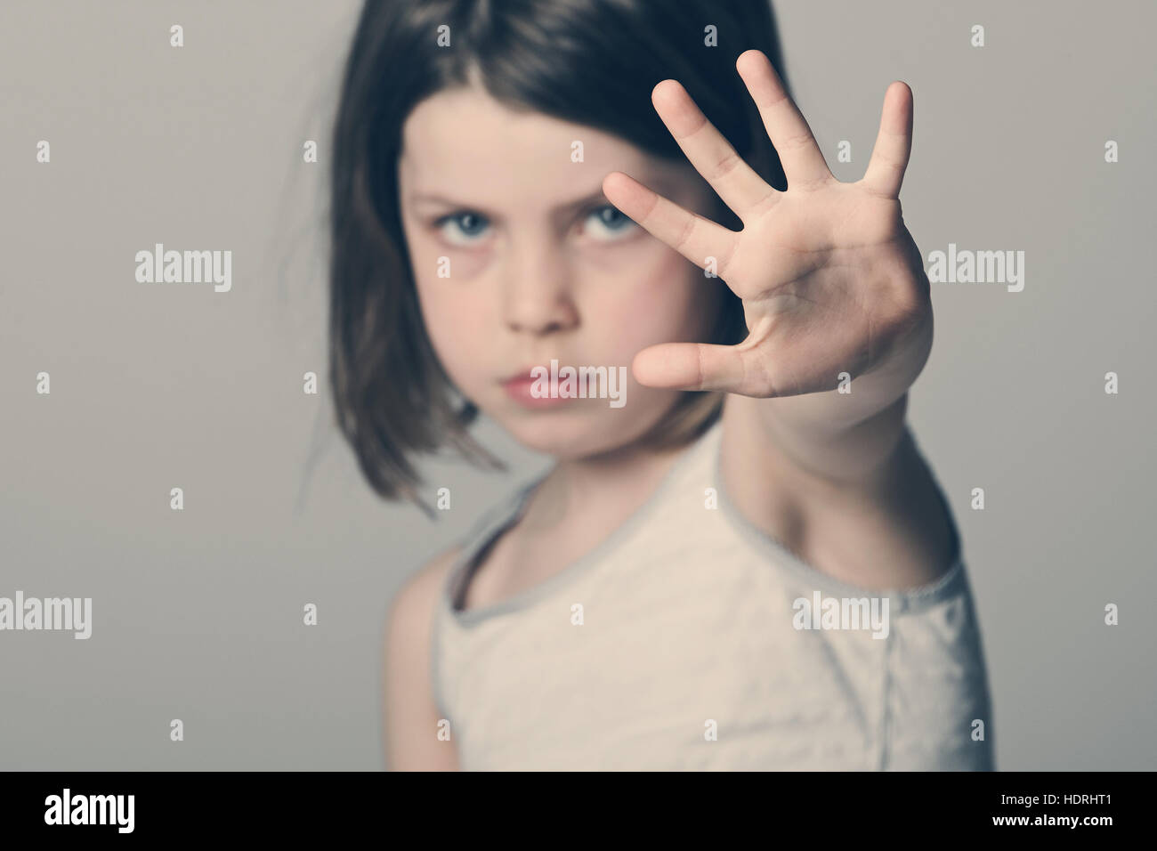 Powerful shot of a child with her hand up Stock Photo