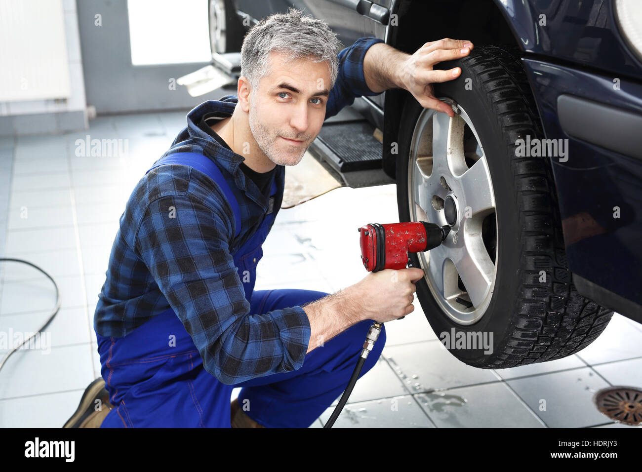 Mechanic adjusts the wheel alignment. Car repair shop, tire service. Tire service, regeneration