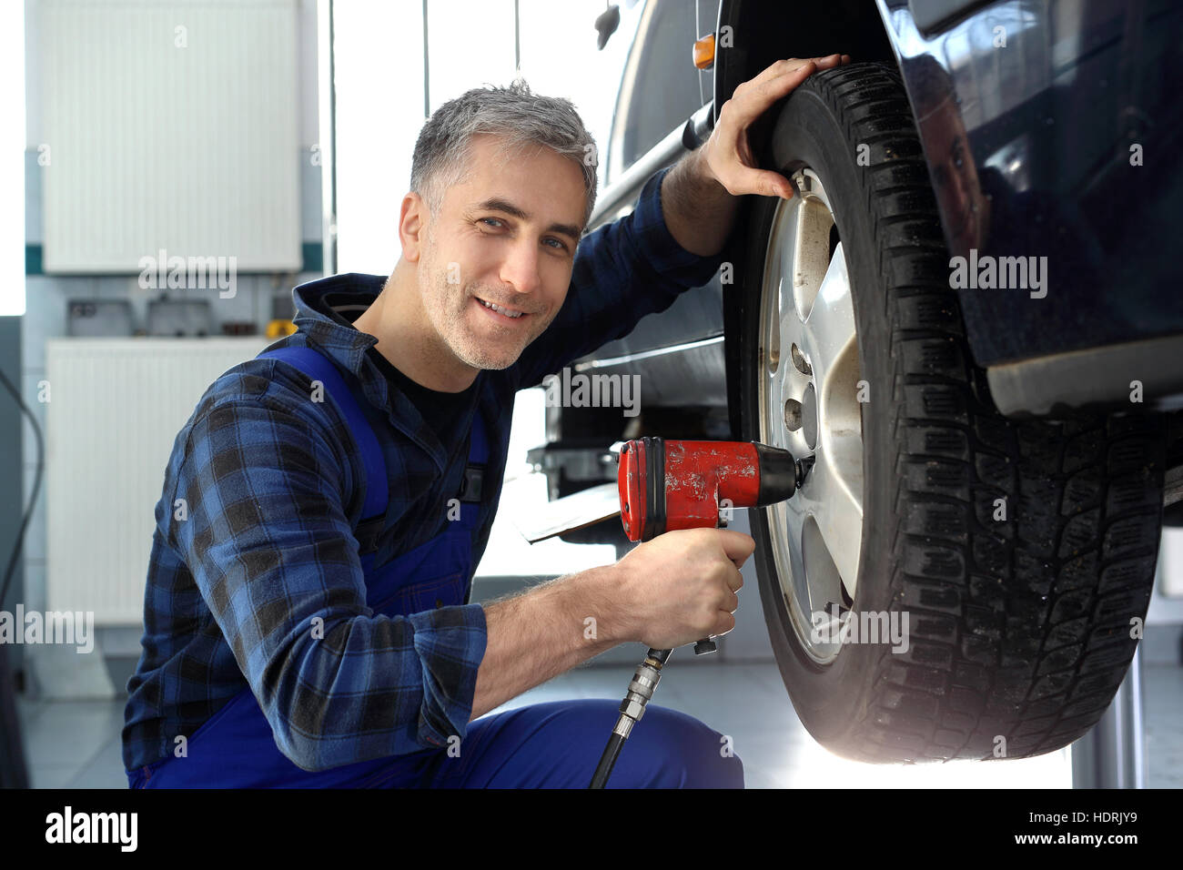 Mechanic adjusts the wheel alignment. Car repair shop, tire service. Tire service, regeneration