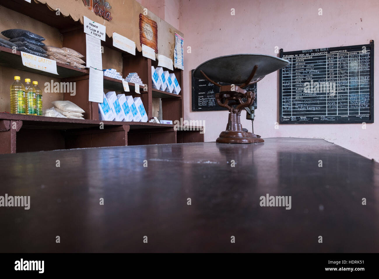 Ration shop in Trinidad, counter, weighing scales and pricelist on blackboard, Cuba Stock Photo