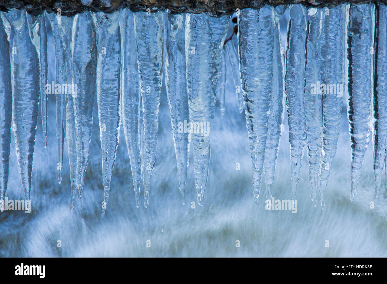Frozen waterfall with blue ice in winter Stock Photo