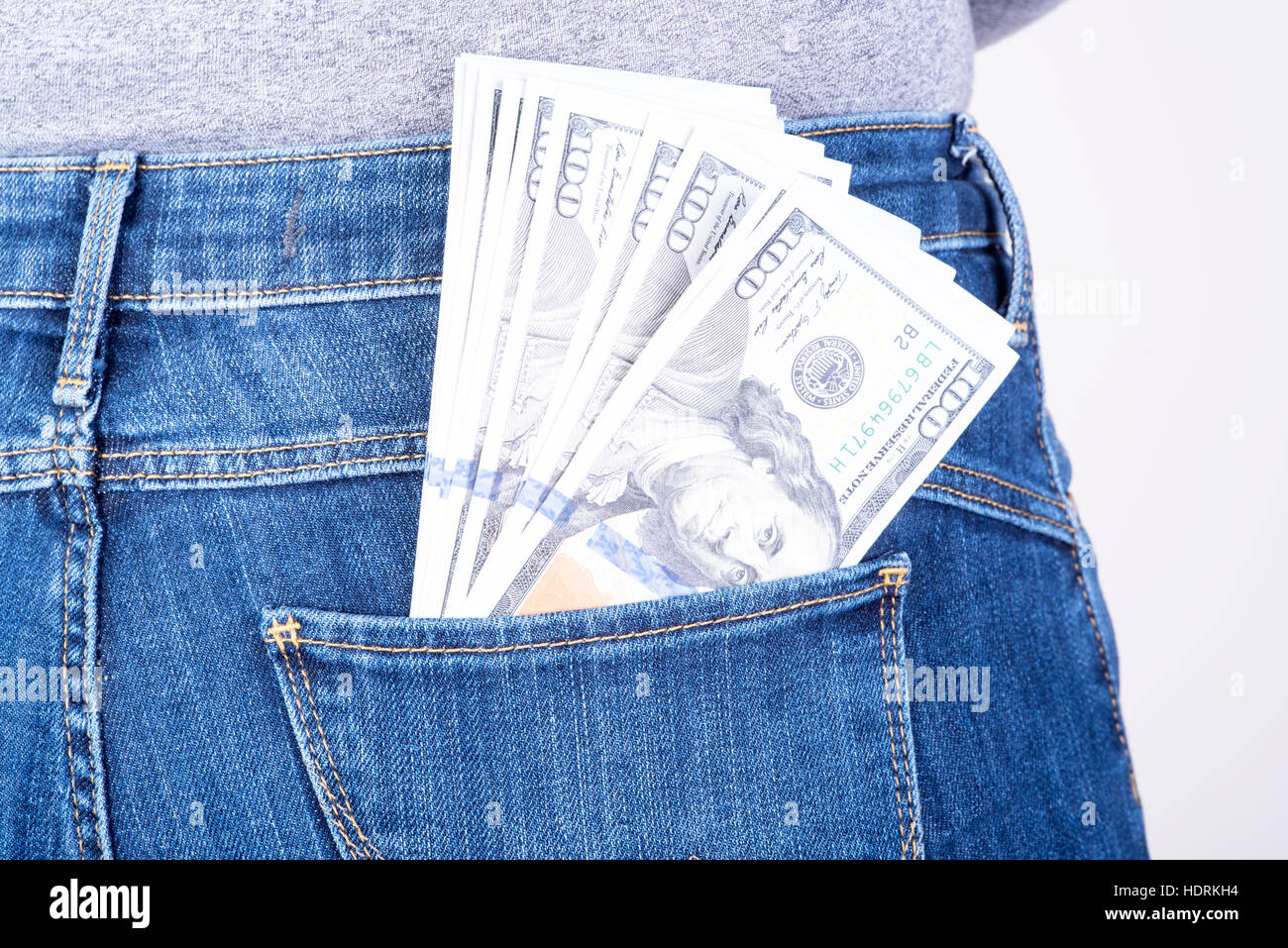 dollars sticking out of his pants pocket Stock Photo