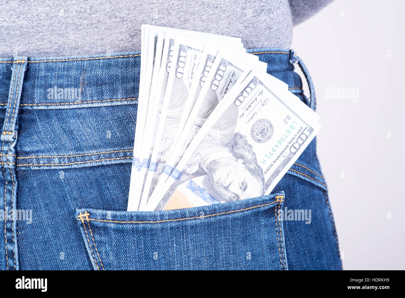 dollars sticking out of his pants pocket Stock Photo