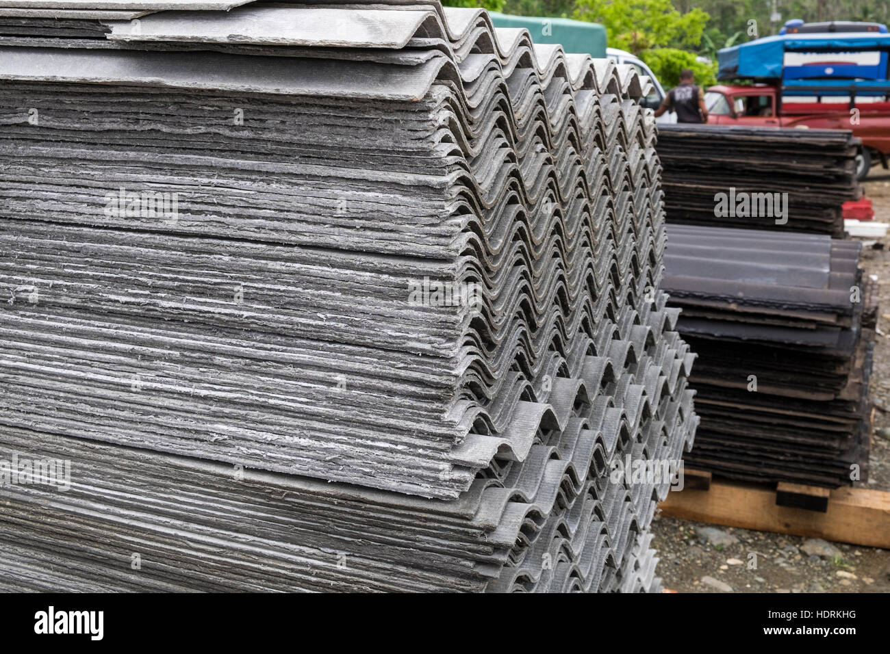 Asbestos corrugated sheeting for roofing piled up ready for distribution to people affected by hurricane Mathew in Baracoa, Cuba Stock Photo