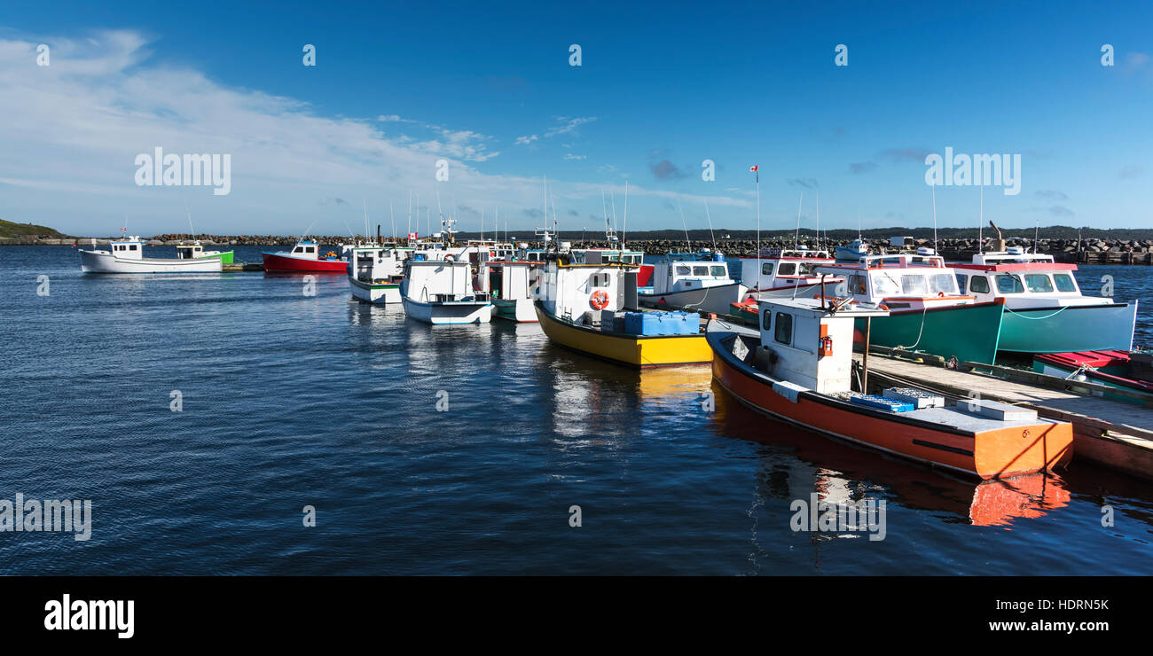 Colourful fishing boats in the harbour; Mainadieu, Nova Scotia
