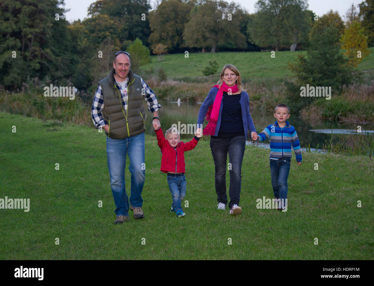 A young family with mother, father and 2 young boys, walking in the countryside. Stock Photo