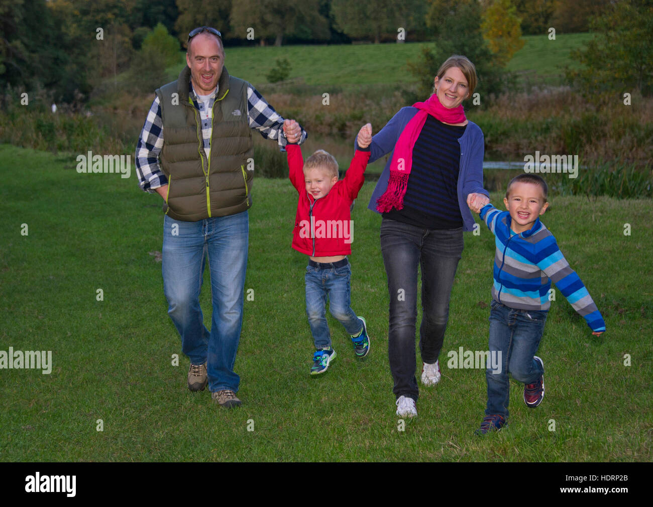 A young family with mother, father and 2 young boys, walking in the countryside. Stock Photo