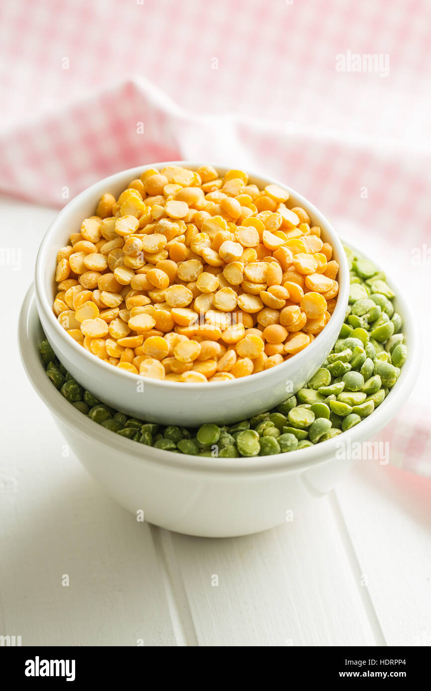 Green and yellow split peas in bowl. Stock Photo