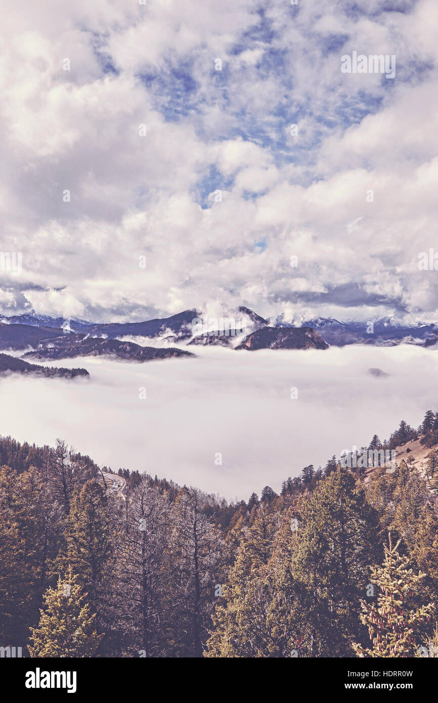Retro toned cloudy mountain landscape, USA. Stock Photo