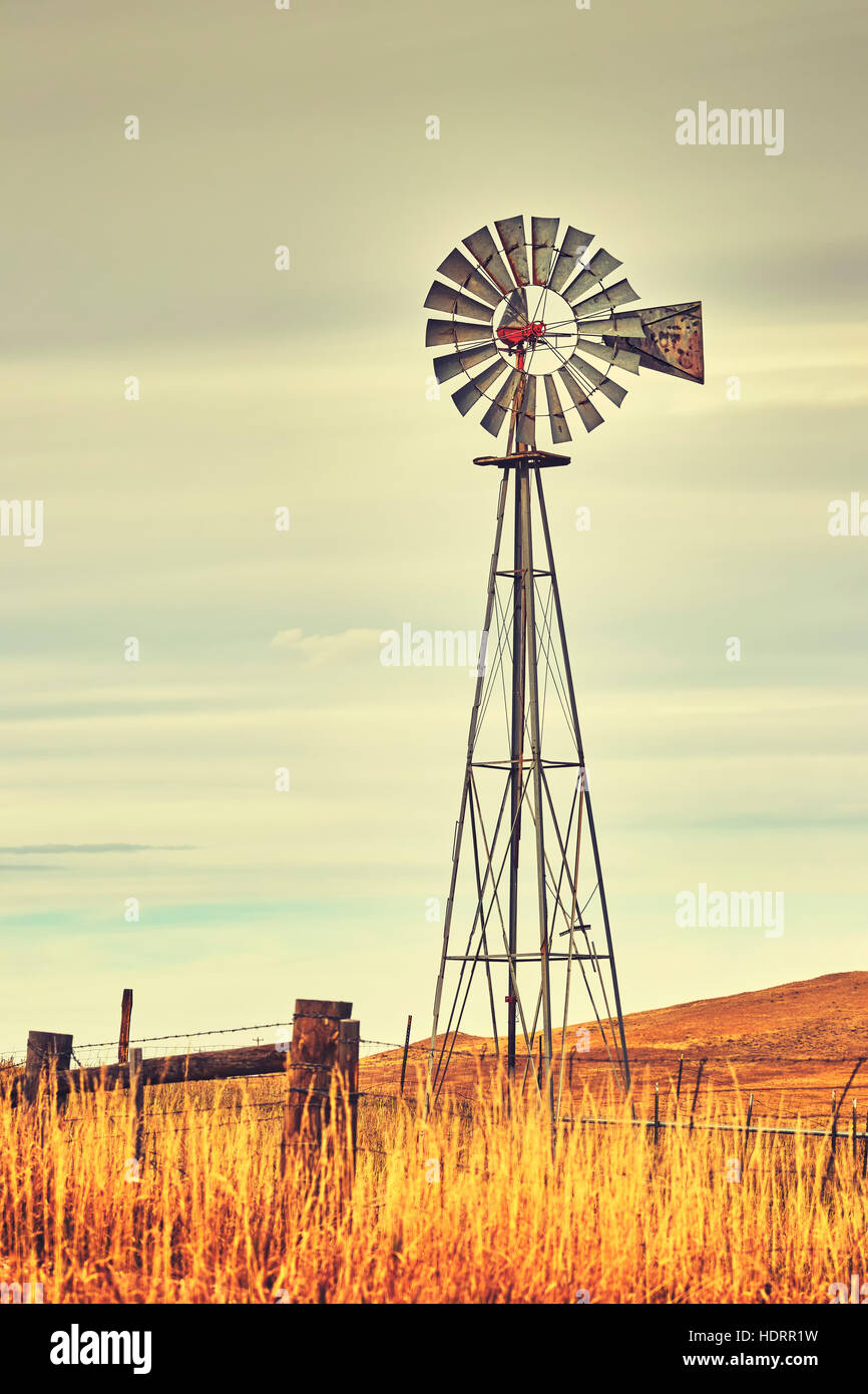 Vintage toned photo of an old western windmill tower, American wild west symbol. Stock Photo