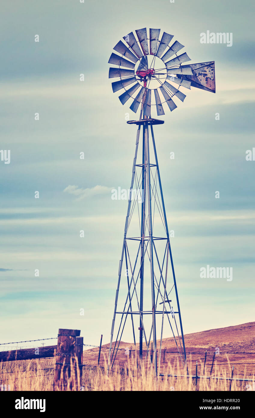 Vintage toned photo of an old western windmill tower, American wild west symbol. Stock Photo