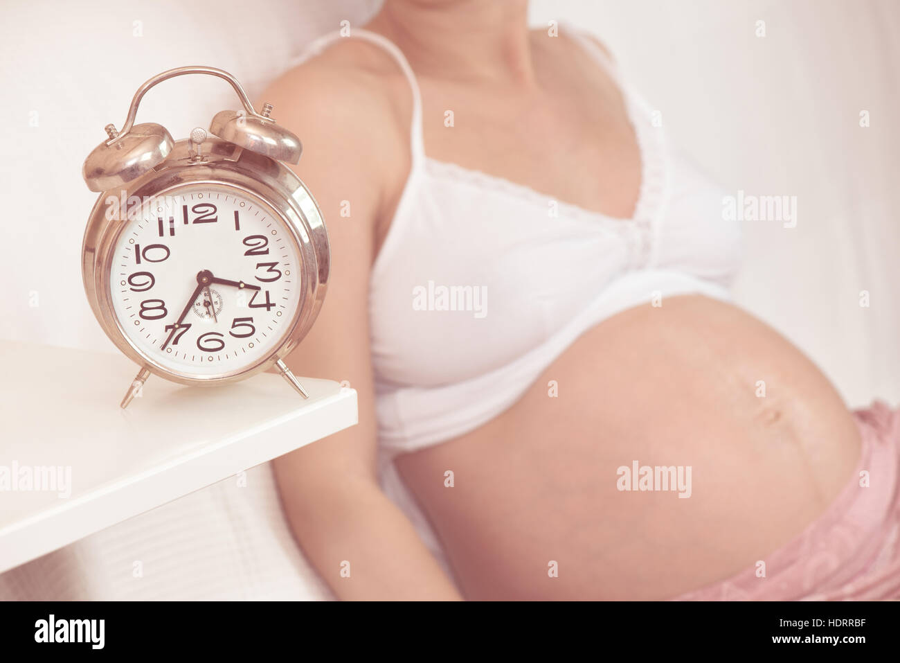Pregnant woman with clock Stock Photo