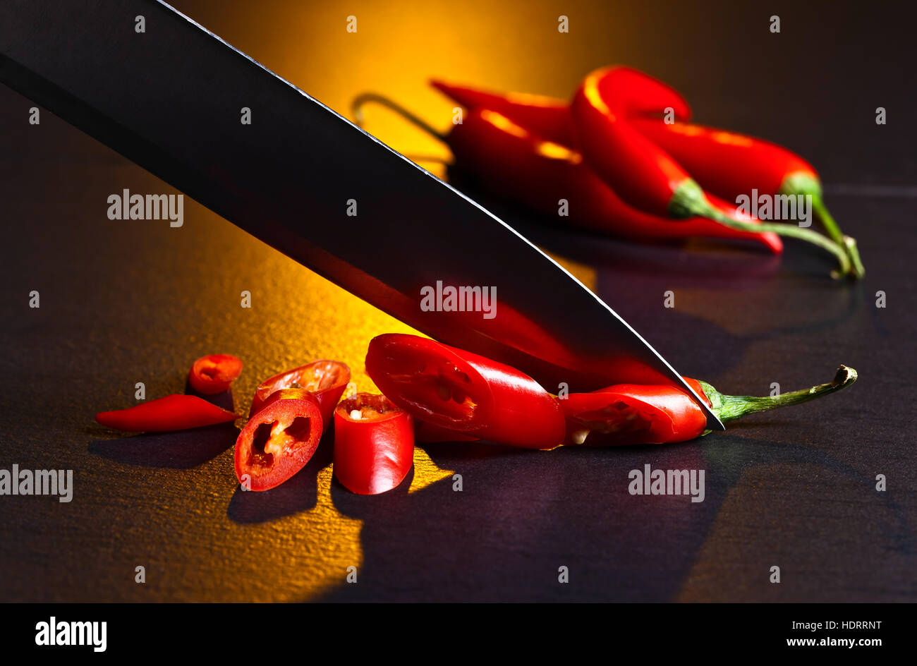 Knife and red chilli pepper on black table Stock Photo Alamy