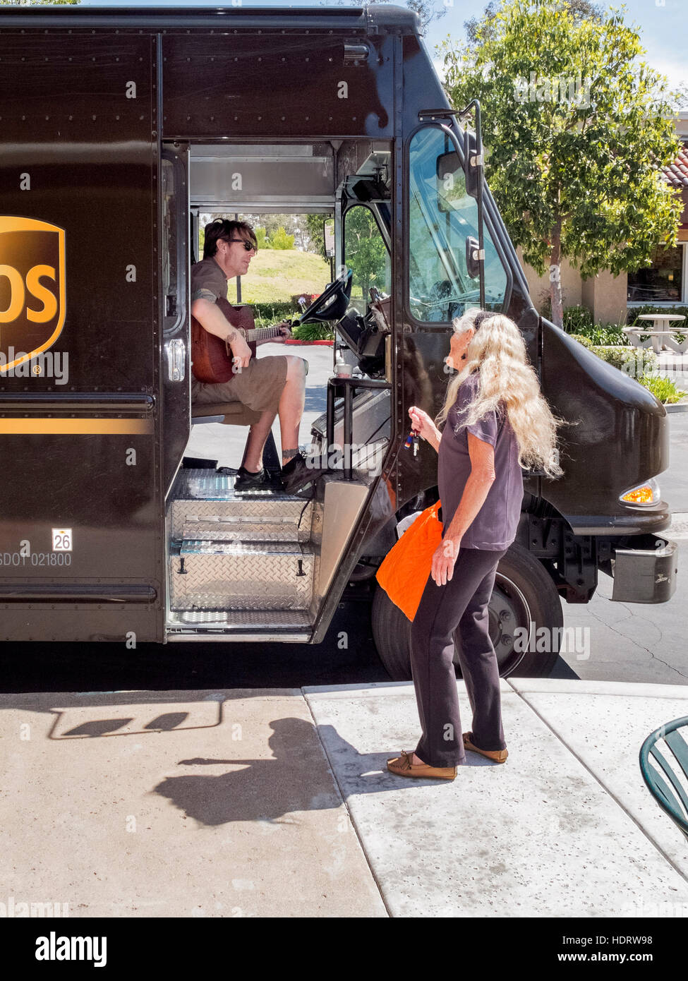 A United Parcel Service (UPS) driver takes time out from deliveries to