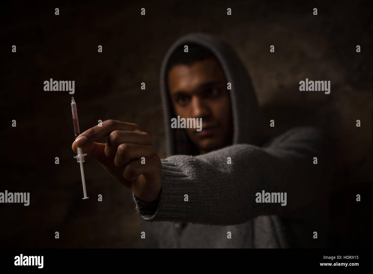 Drug addict posing near brick wall Stock Photo - Alamy