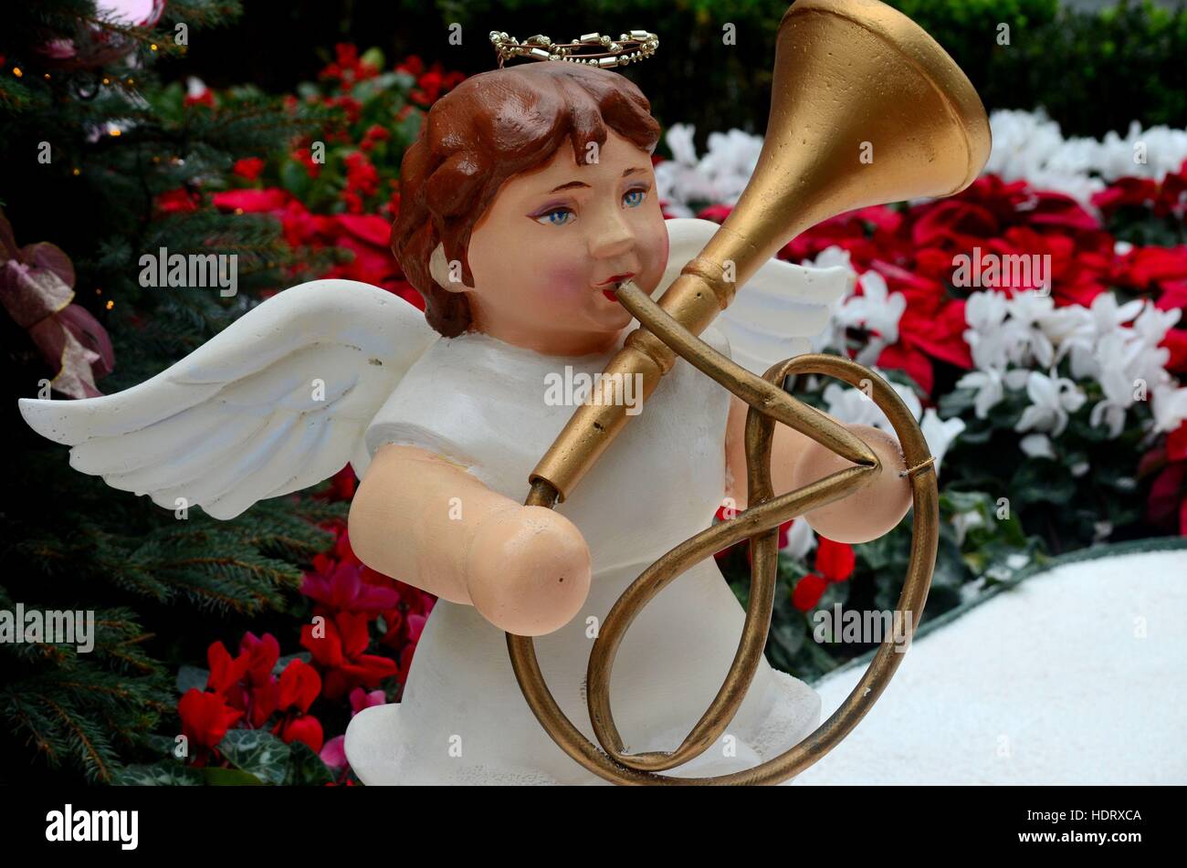 Christmas angel statue plays French horn trumpet brass music instrument