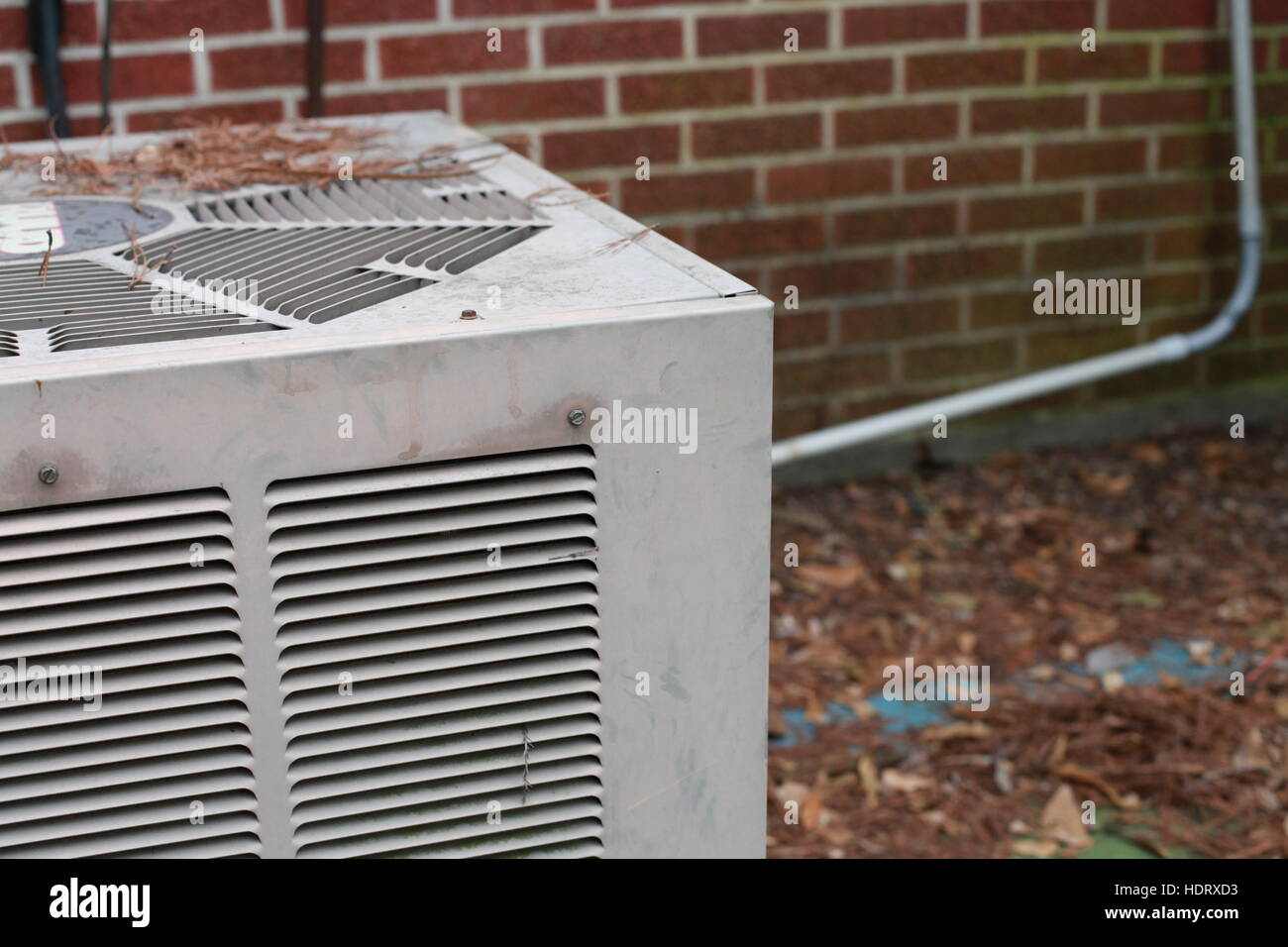 Air conditioning unit outside of red brick building Stock Photo - Alamy