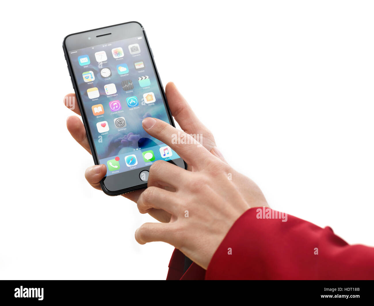 Woman hand holding Apple iPhone 7 Plus and touching screen with a finger isolated on white background Stock Photo